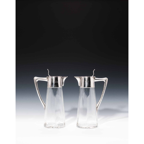 A PAIR OF JUGS WITH SILVER MOUNTS